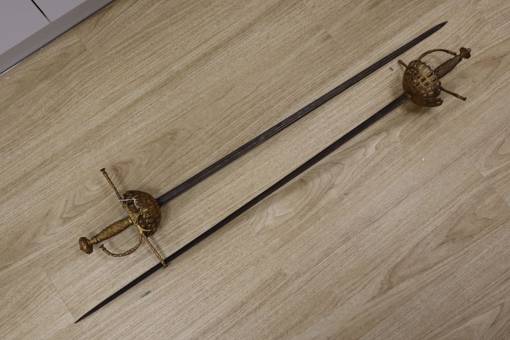 A pair of duelling swords, with cast hilts and 35 inch blades